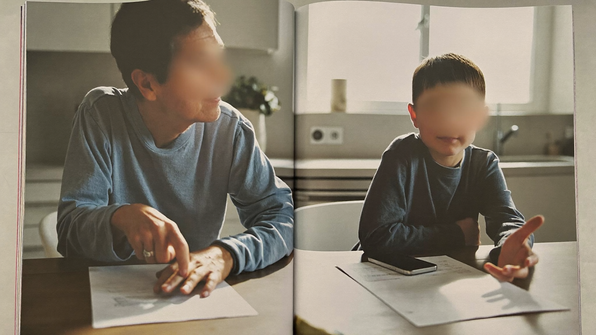 An older homeowner reviewing financial paperwork at a kitchen table with a concerned adult child beside them